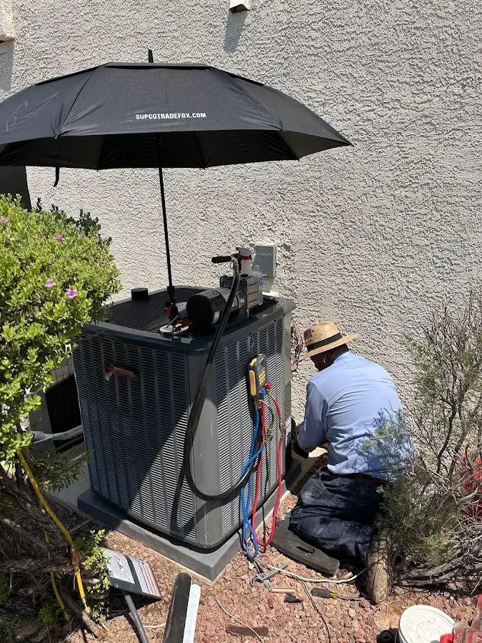 HVAC technician performing outdoor AC maintenance in Tiburon