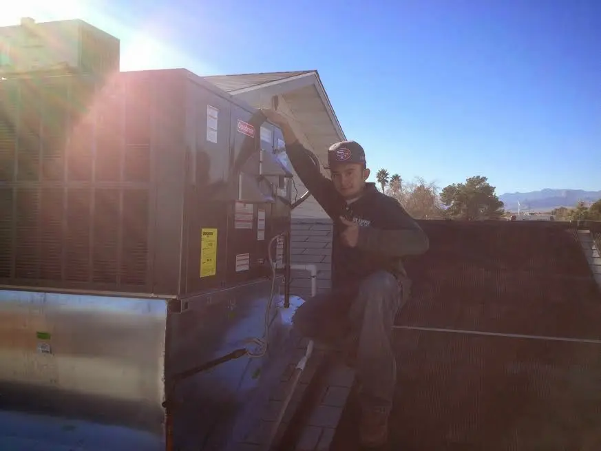 HVAC technician performing Boiler Repair on a rooftop unit in Tiburon